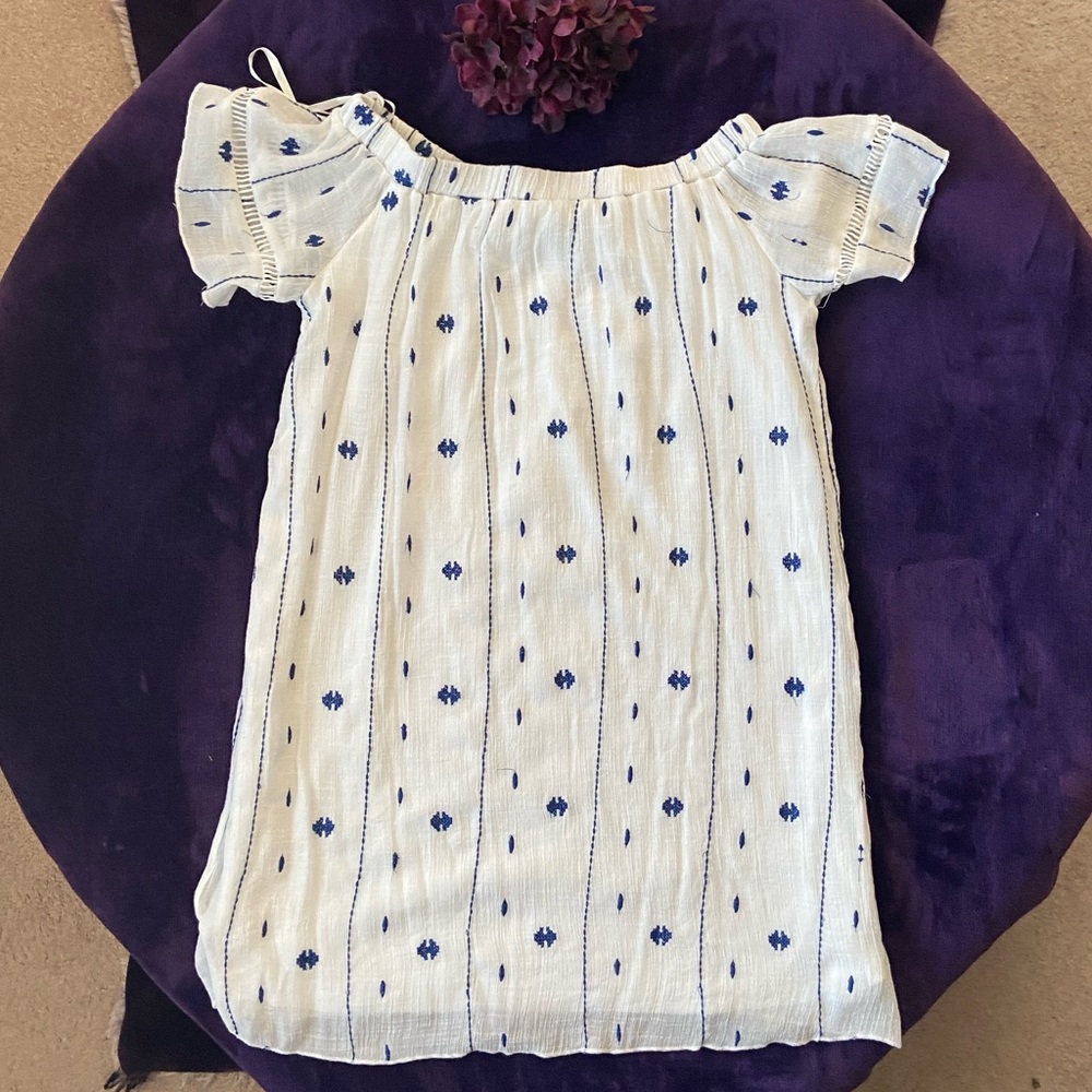 White dress with blue decorations for women.